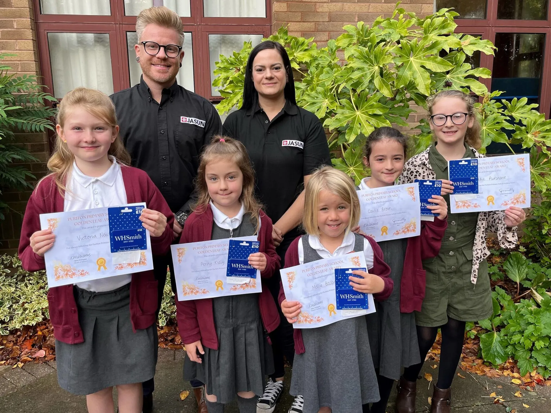 Jason Day LEV Division Manager and Eloise Day Marketing Assistant at Jasun Envirocare with children from Puriton Primary School